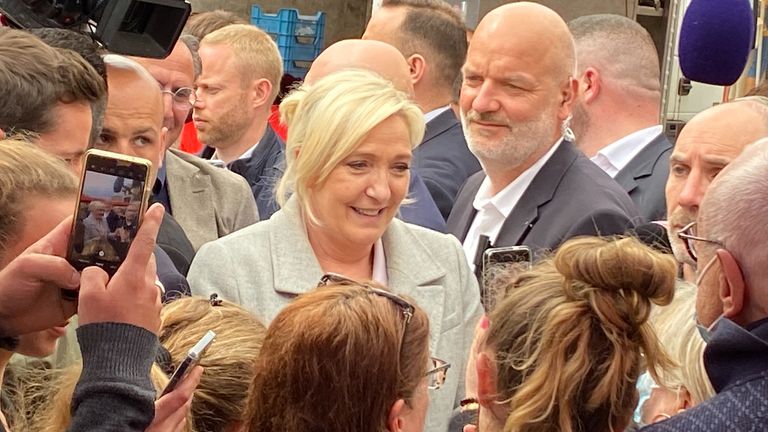 Marine Le Pen was surrounded by well-wishers, reporters and security officers 