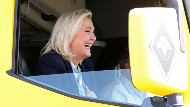 Marine Le Pen, French far-right National Rally (Rassemblement National) party candidate for the 2022 French presidential election, reacts as she sits in a truck during a visit at a truck stop in Roye as she campaigns near Arras, ahead of the second round of the presidential election, France, April 21, 2022. REUTERS/Yves Herman
