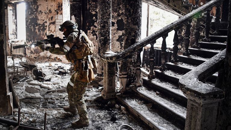   A Russian soldier patrols at the Mariupol drama theatre, bombed last March 16, on April 12, 2022 in Mariupol, as Russian troops intensify a campaign to take the strategic port city, part of an anticipated massive onslaught across eastern Ukraine, while Russia&#39;s President makes a defiant case for the war on Russia&#39;s neighbour. - *EDITOR&#39;S NOTE: This picture was taken during a trip organized by the Russian military.* (Photo by Alexander NEMENOV / AFP) 