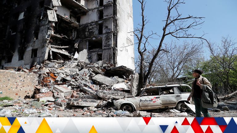 A local resident looks at a block of flats, which was destroyed during Ukraine-Russia conflict in the southern port city of Mariupol, Ukraine April 29, 2022. REUTERS/Alexander Ermochenko