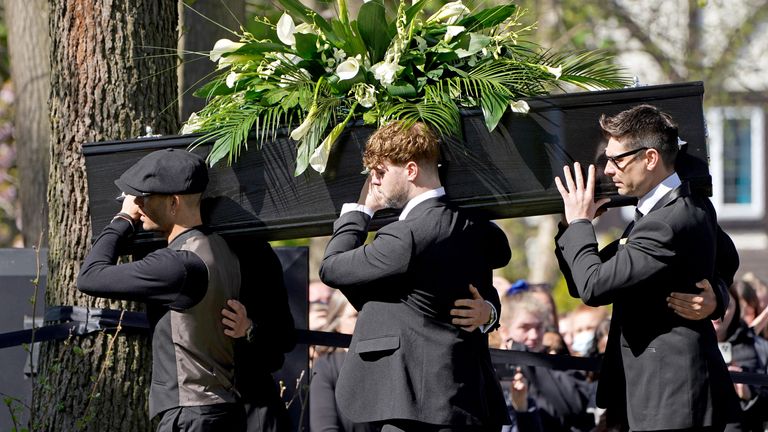 Max George (left) and Jay McGuiness of The Wanted (centre) carry the coffin at the funeral of their bandmate Tom Parker at St Francis of Assisi church in Queensway, Petts Wood, in south-east London, following his death at the age of 33 last month, 17 months after being diagnosed with an inoperable brain tumour. Picture date: Wednesday April 20, 2022.
