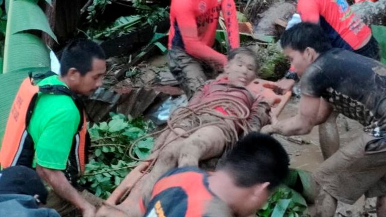 Rescuers carry a person injured in a landslide caused by the tropical storm Megi in Leyte Province, Philippines April 11, 2022. Picture taken April 11, 2022. Philippine Coast Guard/Handout via REUTERS THIS IMAGE HAS BEEN SUPPLIED BY A THIRD PARTY. MANDATORY CREDIT. NO RESALES. NO ARCHIVES
