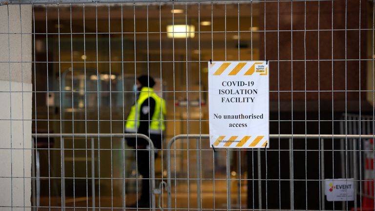 A security worker stands behind a fence at the Crowne Plaza Hotel that is used as a quarantine facility in Auckland, New Zealand, July 30, 2020. Pic: Sylvie Whinray/New Zealand Herald via AP                                                                                                                                                                                                                                                                                                        
