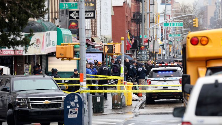 Officers with bomb-sniffing dogs look over the area after a shooting on a subway train Tuesday, April. 12, 2022, in the Brooklyn borough of New York. Multiple people were shot and injured Tuesday at a subway station in New York City during a morning rush hour attack that left wounded commuters bleeding on a train platform.(AP Photo/Kevin Hagen)


