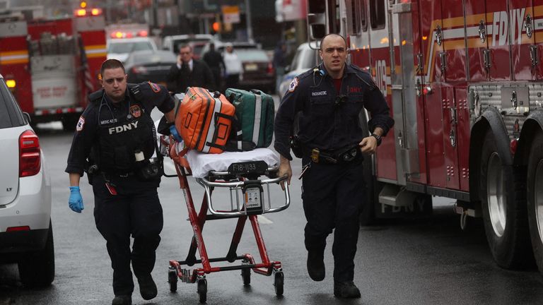 Emergency personnel work near the scene of a shooting at a subway station in the Brooklyn borough of New York City, New York, U.S., April 12, 2022. REUTERS/Brendan McDermid 