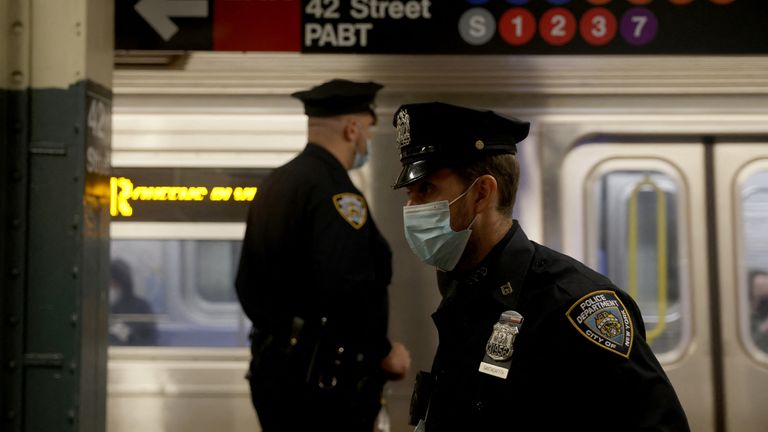 Police and security officers patrol Manhattan subways after a shooting at a subway station in the Brooklyn borough of New York City, New York, U.S., April 12, 2022. REUTERS/Jeenah Moon
