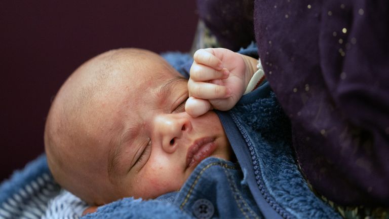 Two-week-old baby Mohammed Ibrahim sleeps in his mothers arms at Northwick Park Hospital in Harrow. Lalene Malik, 23, went to A&E with stomach cramps on March 26 and gave birth to her baby in the toilets, having not known she was pregant and with no outward physical signs of pregnancy. Picture date: Wednesday April 13, 2022. 