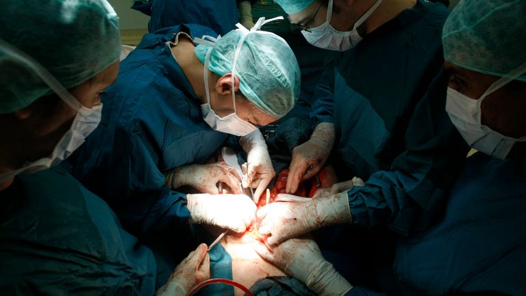 Surgeons extract the liver and kidneys of a brain-dead woman for organ transplant donation at a hospital in Berlin