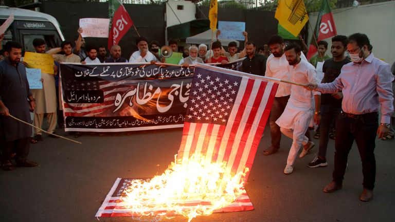 Pakistani Shiite Muslims and supporters of ruling party Pakistan Tehreek-e-Insaf burn a representation of U.S flag during an anti U.S protest. Pic: AP