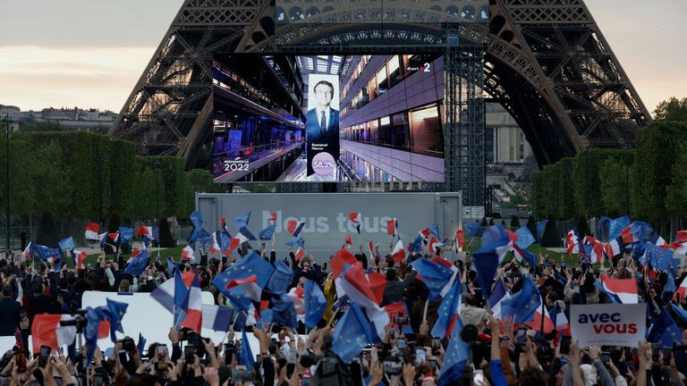 Supporters of French President Emmanuel Macron, candidate for his re-election, react after results were announced in the second round vote of the 2022 French presidential election, near Eiffel Tower, at the Champs de Mars in Paris, France April 24, 2022. REUTERS/Benoit Tessier
