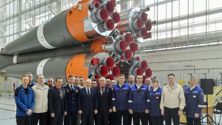 Russian President Vladimir Putin with employees at the Vostochny Cosmodrome