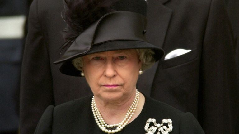 Britain&#39;s Queen Elizabeth II watches as Queen Elizabeth the Queen Mother&#39;s coffin is driven from Westminster Abbey, London.  After the service, the Queen Mother&#39;s coffin will be taken to St George&#39;s Chapel in Windsor, where she will be laid to rest.  * ... next to her husband, King George VI.