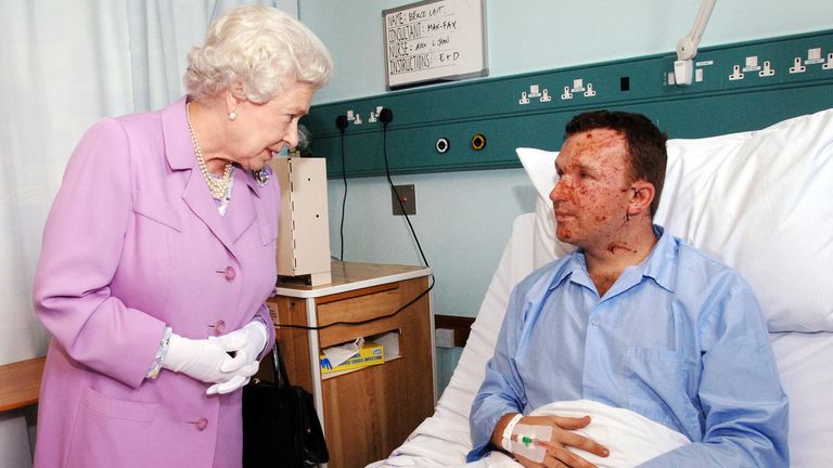 Britain&#39;s Queen Elizabeth II meets Bruce Lait, 32, a professional dancer from Ipswich at the Royal London Hospital in London&#39;s east end. Mr Lait was on the tube train travelling between Aldgate Station and Liverpool Street Station yesterday morning, when a bomb exploded.