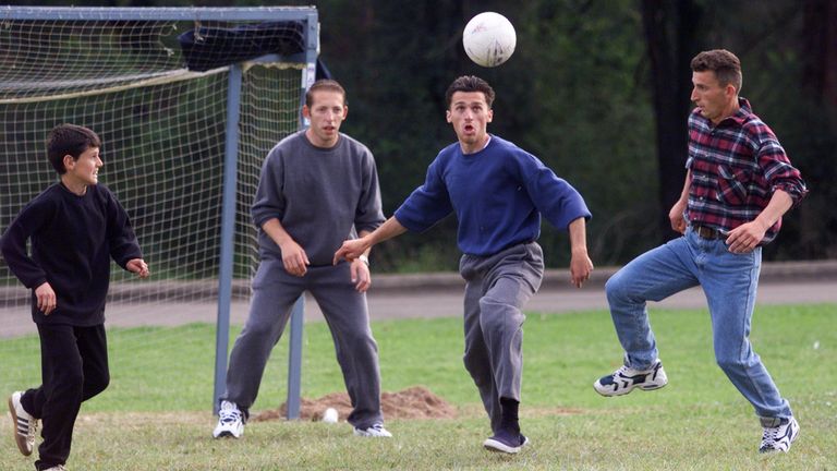 Some of 410 displaced Kosovars who have been granted temporary safe haven in Australia, enjoy a game of soccer May 9. The refugees are undergoing extensive medical screening at an army barracks in Sydney&#39;s south west before they move to another camp on the island state of Tasmania. Australia has agreed to accept 4000 refugees, driven out of their homeland by Serb forces attempting to clear the Yugoslav province of ethnic Albanians. MDB/JIR

