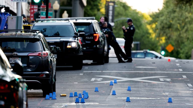 Evidence markers are seen on the ground at the crime scene after an early-morning shooting in Sacramento, California