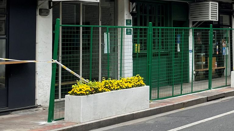 Green fences seal entrances to shops and housing units along a street, amid the coronavirus disease (COVID-19) outbreak in Shanghai, China April 24, 2022. REUTERS/Jacqueline Wong