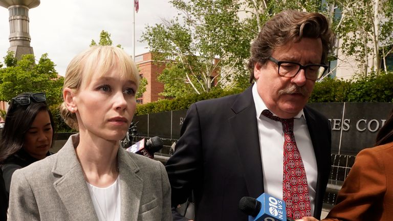 Sherri Papini of Redding walks to the federal courthouse accompanied by her attorney, William Portanova, right, in Sacramento, Calif., Wednesday, April 13, 2022. Papini was arraigned on 34 counts of mail fraud and one count of making false statements. She is expected to plead guilty Monday, April 18, 2022, to a single count of mail fraud and one count of making false statements under a plea agreement. Papini who was charged last month with faking her kidnapping in 2016, accepted a plea bargain with prosecutors Tuesday. (AP Photo/Rich Pedroncelli)......