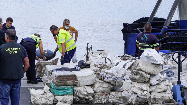 Police officers discharge drugs from the fishing boat "AKT-1" seized south of the Canary Islands in the port of Las Palmas, in the island of Gran Canaria, Spain, April 16, 2022. REUTERS/Borja Suarez
