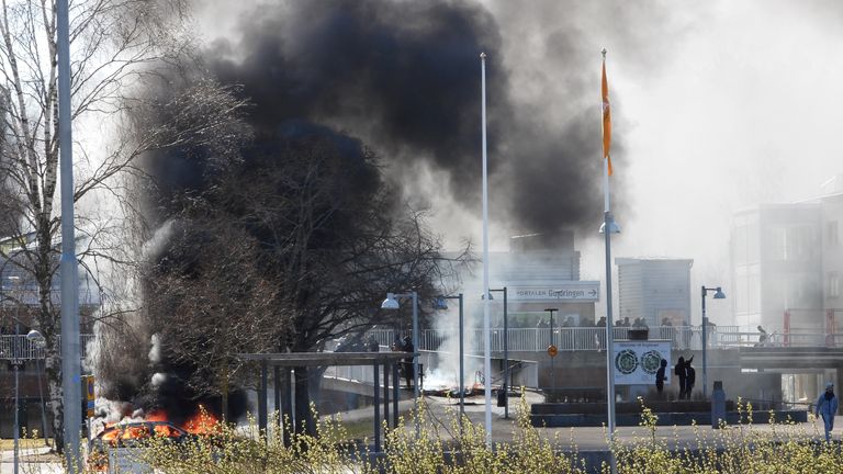 Smoke billows from a burning car during a riot ahead of a demonstration planned by Danish anti-Muslim politician Rasmus Paludan and his Stram Kurs party, which was to include a burning of the Muslim holy book Koran, in Navestad, Norrkoping, Sweden April 17, 2022, in this handout image obtained by Reuters on April 17, 2022. Ulf Wigh/Wighsnews/Handout via REUTERS THIS IMAGE HAS BEEN SUPPLIED BY A THIRD PARTY. MANDATORY CREDIT.