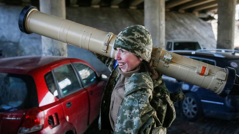 Tetiana Chornovol, former member of the Ukrainian Parliament   carries an anti-tank missile at a position on the front line in Kyiv on March 20