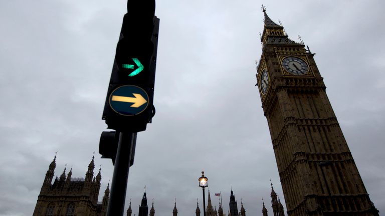 A traffic light illuminates next to the Big Ben clock tower in London, Monday, Oct. 10, 2011. Big Ben has a little bend. Experts say the world-famous neogothic clock tower is listing gently, and documents recently published by Britain&#39;s Parliament show that the top of its gilded spire is about one-and-a-half feet (nearly half a meter) out of line. The tower, colloquially known as Big Ben after its massive bell - has been slightly off center since it was erected in the 19th century. Like many old