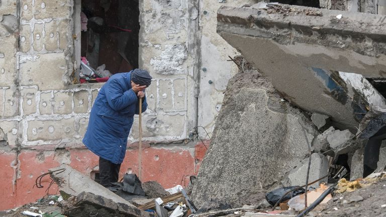 A woman cries as she tries to find a body of her son among debris of a residential destroyed during Russia’s invasion in the town of Borodianka