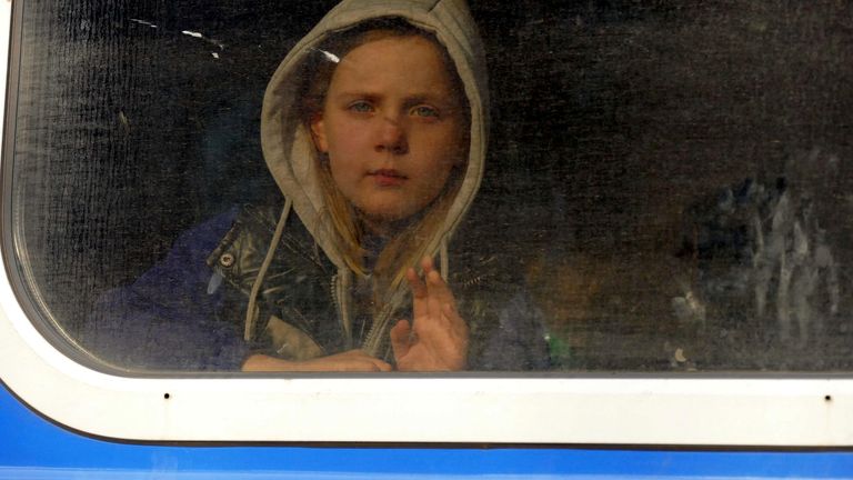 A girl looks out a window aboard a train as people travel to Przemysl, Poland, amid Russia&#39;s invasion of Ukraine, in Odesa, Ukraine, April 25, 2022. REUTERS/Igor Tkachenko