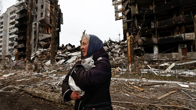 A woman carries her cat as she walks past buildings that were destroyed by Russian shelling, amid Russia's invasion of Ukraine in Borodyanka, in the Kyiv region, Ukraine, April 5, 2022. REUTERS/Zohra Bensemra TPX IMAGES OF THE DAY
