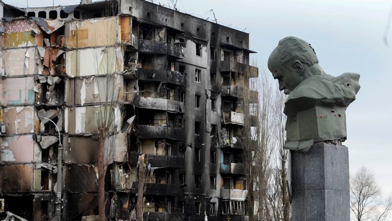 A monument to Taras Shevchenko, a Ukrainian poet and a national symbol, stands near an apartment ruined in the Russian shelling in the central square in Borodyanka, Ukraine, Wednesday, Apr. 6, 2022. (AP Photo/Efrem Lukatsky)                                                   