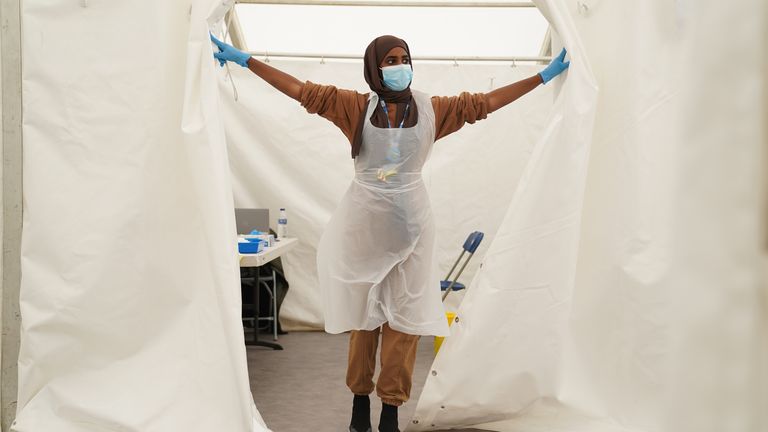 A NHS worker looks for patients at a Covid-19 pop-up vaccination centre during a four-day vaccine festival in Langdon Park, Poplar, east London. Picture date: Saturday July 31, 2021.

