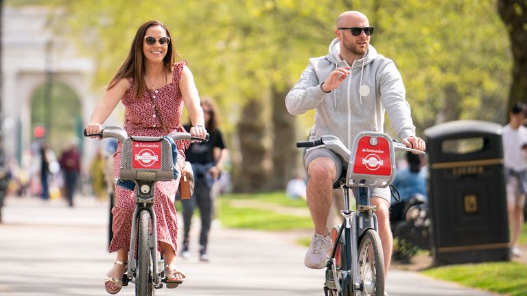 Cyclists ride Santander hire bikes in Hyde Park, as people enjoy the warm weather in London. Parts of the UK are enjoying warmer weather than usual on Easter Sunday as the spate of high temperatures continues. Picture date: Sunday April 17, 2022.


