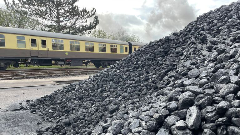 Around 50 tonnes of Welsh coal is piled in the yard beside the track in Toddington