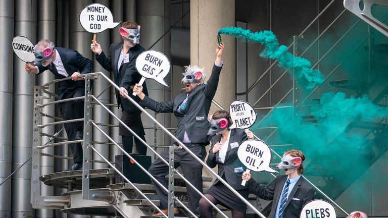 Activists from Extinction Rebellion stand on a stairwell at Lloyds of London, in the City of London, as they call for Lloyds to stop insuring fossil fuel projects worldwide. Picture date: Tuesday April 12, 2022.