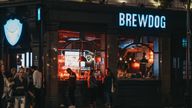 London, UK - August 31, 2019: People standing outside Brewdog pub in Covent Garden, one of the most popular tourist sites in London, UK. In the evening, selective focus.