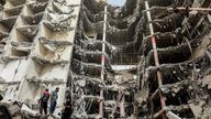 In this photo provided by Tasnim News Agency, debris hangs from the Metropol buildin,g a 10-story commercial building under construction, in the southwestern city of Abadan, Iran, Tuesday, May 24, 2022. Rescuers dug through debris Tuesday of the collapsed building that killed at least 11 people, fearful that many more could still be trapped beneath the rubble as authorities arrested the city&#39;s mayor in a widening probe of the disaster. (Hossein Abdollah Asl, Tasnim News Agency via AP)