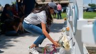 Meghan Markle, Duchess of Sussex, leaves flowers at a memorial site, Thursday, May 26, 2022, for the victims killed in this week&#39;s elementary school shooting in Uvalde, Texas. (AP Photo/Jae C. Hong)