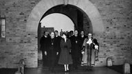 Queen visits xxQueen Elizabeth II and Prince Philip visiting Birmingham, West Midlands. Pictured, the Queen leaves the new Shard End Church, All Saints Church, accompanied by (left) the Lord Bishop of Birmingham, Leonard Wilson, and with Lord Mayor Alderman A L Gibson and Bishop of Aston, The Right Reverend Clement George St Michael Parker in attendance. 3rd November 1955