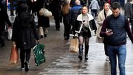 FILE PHOTO: Shoppers walk on Oxford Street, as rules on wearing face coverings in some settings in England are relaxed, amid the spread of the coronavirus disease (COVID-19) pandemic, in London, Britain, January 27, 2022. REUTERS/Toby Melville/File Photo