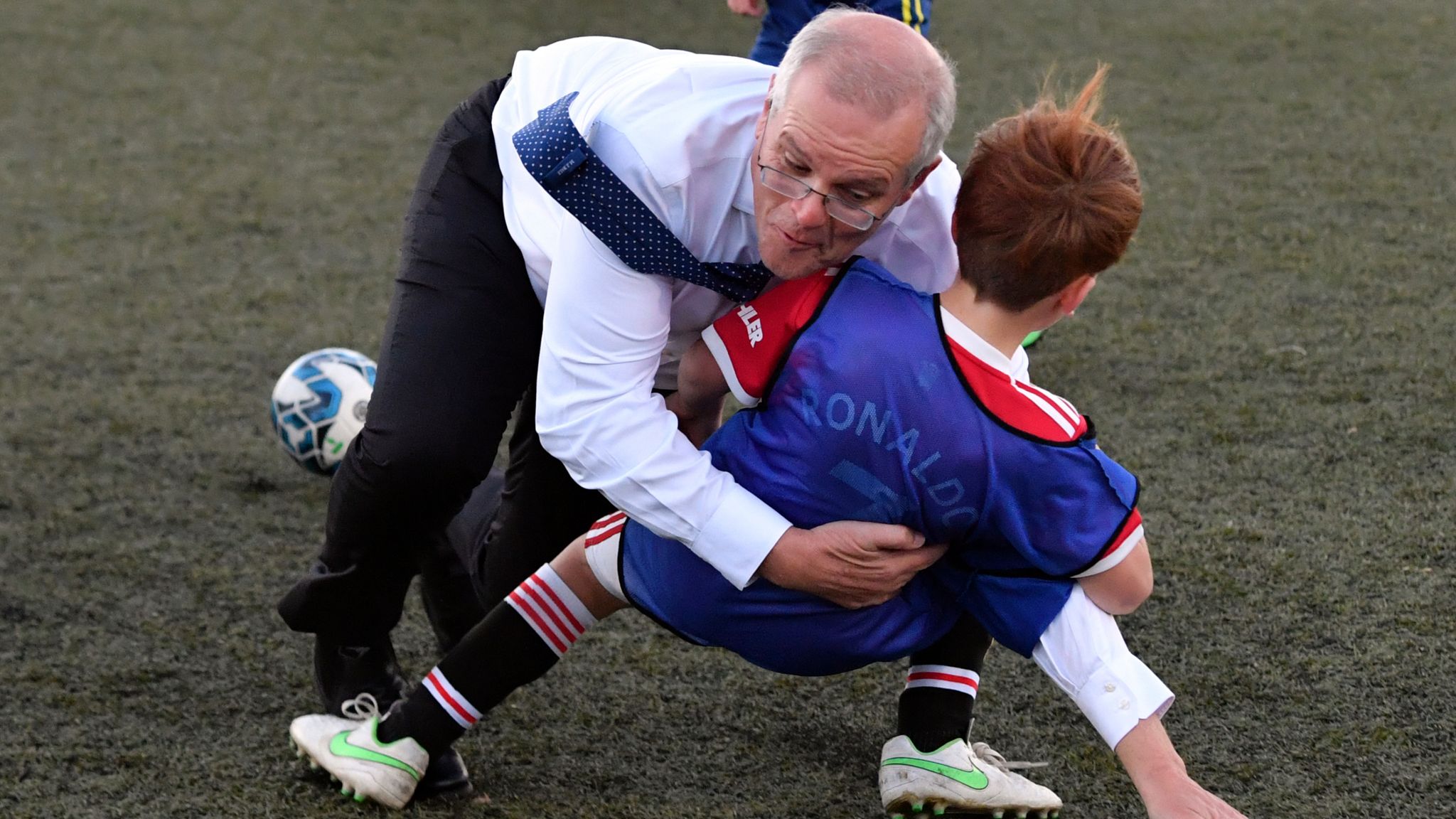 Australian PM Scott Morrison accidentally rugby tackles boy during football  match at election event | World News | Sky News