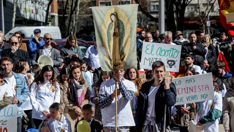Several people take part in an anti-abortion march, called by the Catholic association Enraizados, near the Plaza de Cuzco, on April 2, 2022, in Madrid (Spain). This mobilization, which joins one held in San Sebastian, aims to stop a law that imposes penalties on those who offer mothers alternatives to abortion. This march is being held under the slogan &#39;Prayer is not a crime&#39;. 02 APRIL 2022;PROTEST;ABORTION;PRO-LIFE Ricardo Rubio / Europa Press 04/02/2022 (Europa Press via AP)