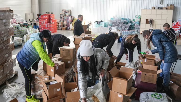 Volunteers sort humanitarian aid in Zaporizhia, Ukraine, Tuesday, March 22, 2022. (AP Photo/Evgeniy Maloletka)