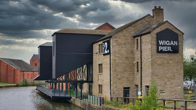 Warehouse buildings on Wigan Pier on the Leeds - Liverpool Canal.  Now there is a redevelopment of housing and public entrances.  August 16, 2021