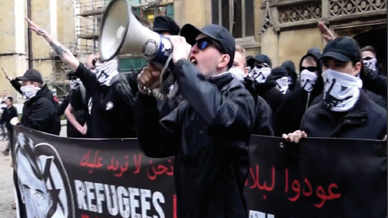 Alex Davies holding a megaphone at a rally by National Action in York, May 2016