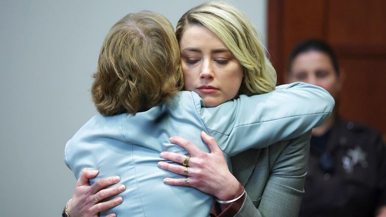 Amber Heard hugs her attorney Elaine Bredehoft after she testified in the courtroom at Fairfax County Courthouse in Fairfax, Va., Thursday, May 26, 2022. Actor Johnny Depp sued his ex-wife Amber Heard for defamation in Fairfax County Court after she wrote an appropriate article in The Washington Post in 2018 introducing herself as "public figure representing domestic abuse." (Michael Reynolds / Pool Photo via AP)