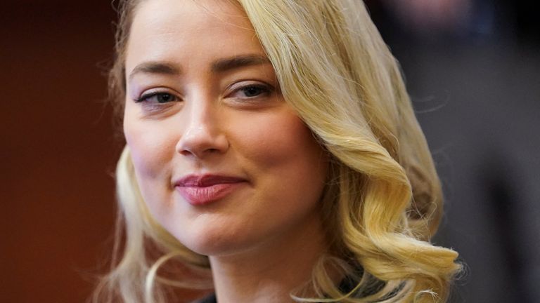 Actor Amber Heard smiles during the defamation case against her by ex-husband actor Johnny Depp in Fairfax County Circuit Court in Fairfax, Virginia, U.S., May 18, 2022.  REUTERS/Kevin Lamarque/Pool