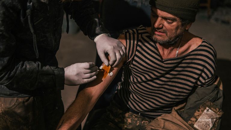 In this photo provided by Azov Special Forces Regiment of the Ukrainian National Guard Press Office, an Azov Special Forces Regiment&#39;s serviceman, injured during fighting against Russian forces, poses for a photographer inside the Azovstal steel plant in Mariupol, Ukraine, Tuesday, May 10, 2022. (Dmytro &#39;Orest&#39; Kozatskyi/Azov Special Forces Regiment of the Ukrainian National Guard Press Office via AP)