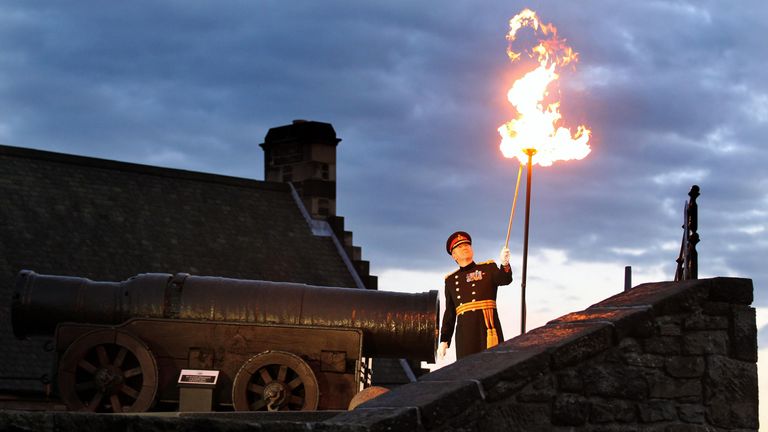 An Army general lights a beacon at Edinburgh Castle