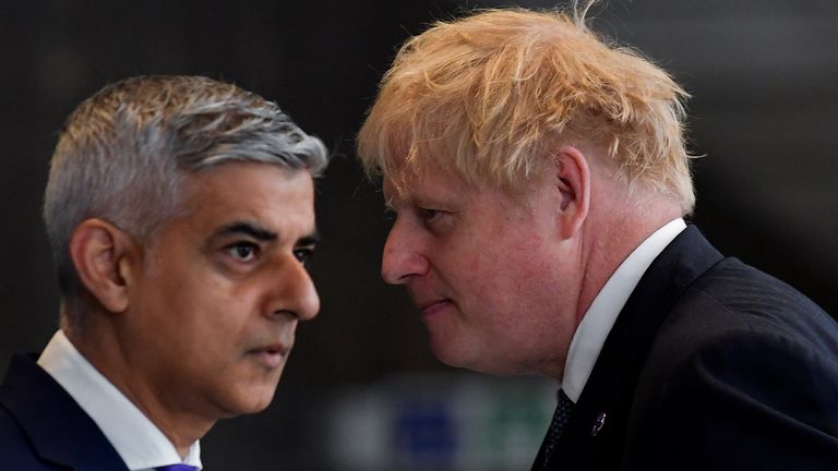 British Prime Minister Boris Johnson and mayor of London Sadiq Khan pass each other during an engagement to mark the completion of the Elizabeth Line at Paddington Station in London, Britain, May 17, 2022. REUTERS/Toby Melville
