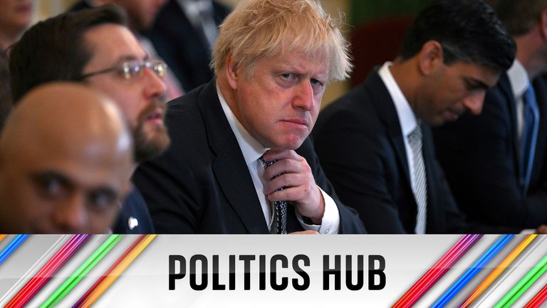 Prime Minister Boris Johnson adjusts his tie at the start of a Cabinet meeting at 10 Downing Street, London. Picture date: Tuesday May 24, 2022.