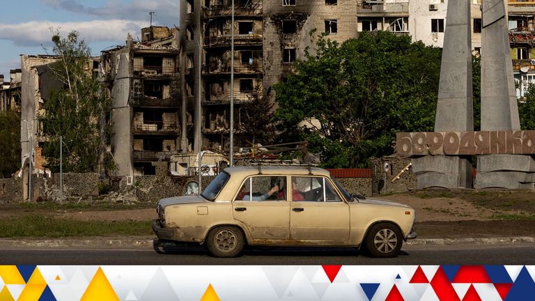 A car drives past in front of destroyed buildings, amid Russia&#39;s invasion of Ukraine, in Borodyanka outside Kyiv, Ukraine May 16, 2022. Picture taken May 16, 2022. REUTERS/Jorge Silva